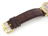 an image of a watch with a brown leather strap on a white surface