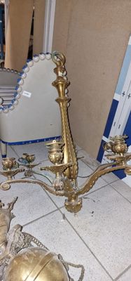 a gold candle holder and a mirror on the floor