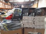 a pile of boxes and boxes of clothing in a warehouse