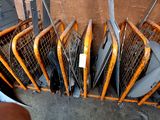 a lot of chairs that are sitting in a pile