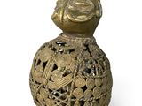 a gold vase with a bird on top of it