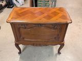 a small table with a wooden top in a room