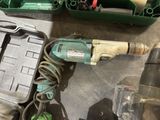 a drill that is sitting on the floor next to other tools