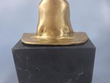 an image of a statue of a cat sitting on top of a black marble block