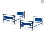 two metal beds with blue rails and a blue foot board