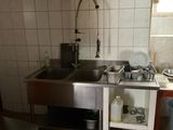 a small kitchen with a sink and a stove in it