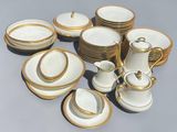 a lot of white and gold plates and cups on the table