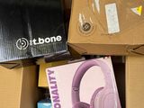 a box of headphones sitting on the floor next to a keyboard