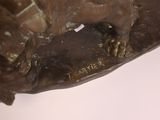 a bronze statue of a dog on a table