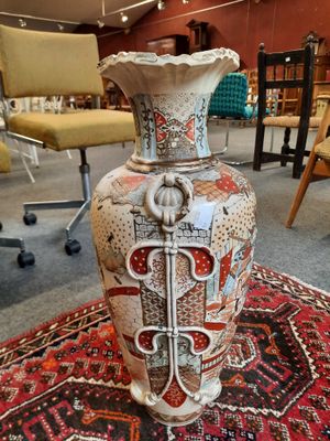 a vase that is sitting on a rug in a room