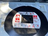 a toilet with stickers on it in the middle of the floor