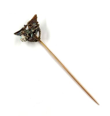 a stick with a bird on it on a white surface