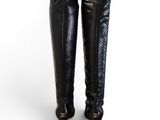 a close up of a pair of black high heeled boots