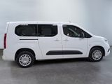 the small white van is parked in a large room