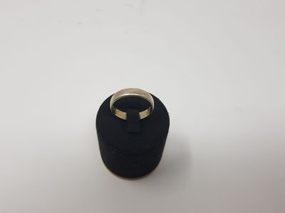 a black ring with a gold ring on top of it
