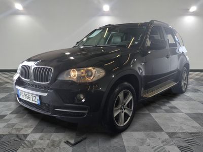 a picture of a black bmw suv parked in a garage