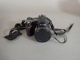 a camera with a strap attached to it sitting on a table