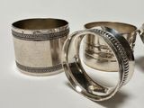 two silver cups sitting next to each other on a table