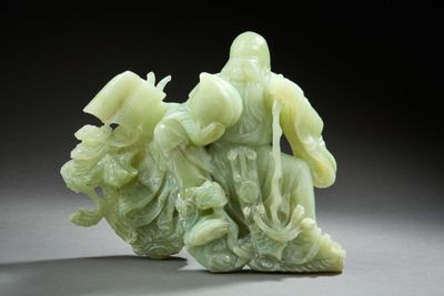 a statue of a man riding a horse on a rock