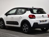 the rear end of a white citrole parked in a room