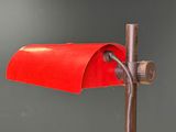 a close up of a red lamp on a metal pole