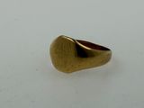 an image of a gold signet ring on a white surface