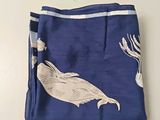 a blue cloth with a white fish on it