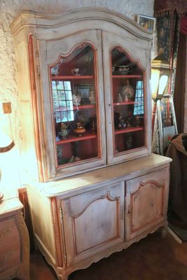 a white china cabinet with glass doors in a room