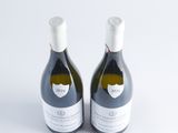two bottles of wine sitting next to each other on a white surface