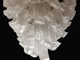 a chandelier made of plastic leaves on a black background