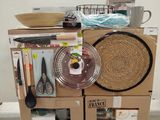 boxes stacked on top of each other in a room with utensils on top of them