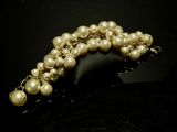 pearl bracelet with gold beads on a black surface