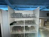 many empty glasses on the shelves in the room