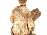 a small statue of a man sitting on a bench