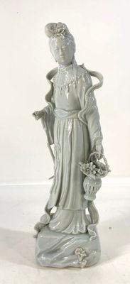 une statue représentant une femme tenant un panier de fleurs