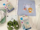 baby items that are on a table with a picture frame