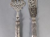 two forks and spoons that are on a table