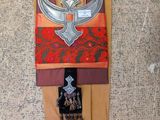 a picture of a wall hanging with a sword and armor on it
