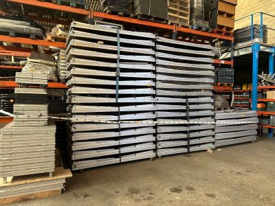 a large stack of steel plates in a warehouse