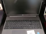 an open laptop computer sitting on top of a desk next to a bag