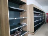 many empty shelves in a store with soda cans on them