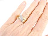 a woman ' s hand with a diamond ring on it
