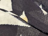 close up of a black and white patterned fabric with a triangle design