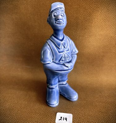a small blue figurine of a man with a hat on