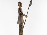 a bronze statue of a man holding a spear and shield
