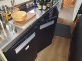 an image of a kitchen with a lot of bottles on the counter