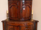 a corner cabinet with a tea pot on top of it