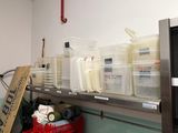 a metal shelf with plastic containers on it in a room