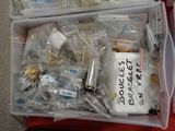 two plastic containers filled with assorted items sitting on top of a red table