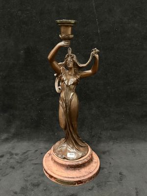 statue en bronze représentant une femme tenant un vase, posée sur un socle en marbre